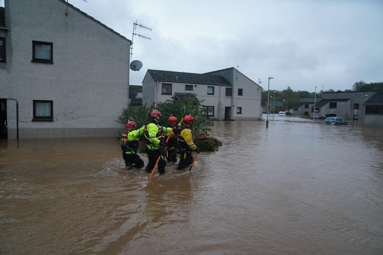 File photo: People are rescued from their flooded homes (PA Wire)