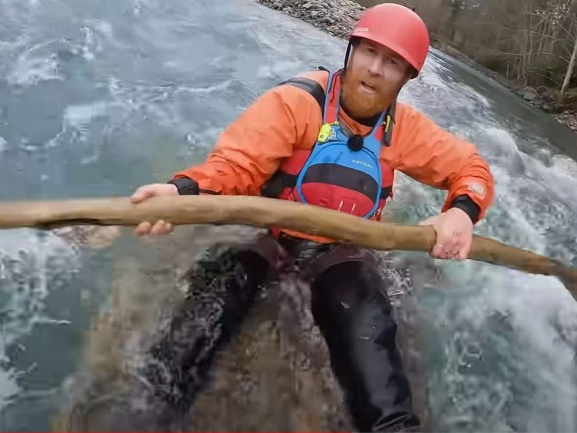 A screengrab from Beau Miles's video showing the Australian YouTuber floating down the Chilliwack River in a raft he made himself. (Beau Miles/YouTube - image credit)