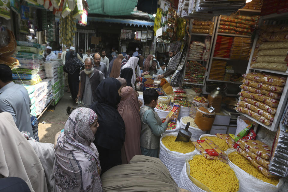 People visit a market to buy grocery and other stuff, ahead of the upcoming Muslim fasting month of Ramadan, in Peshawar, Pakistan, Tuesday, March 21, 2023. Muslims across the world will be observing the Ramadan, when they refrain from eating, drinking and smoking from dawn to dusk. Ramadan is expected to officially begin Thursday or Friday in Pakistan, though the timing depends on the alignment of the moon. (AP Photo/Muhammad Sajjad)