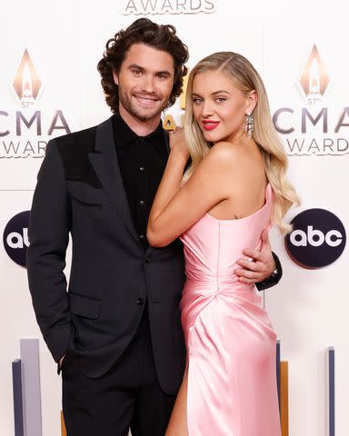 <p>Taylor Hill/WireImage</p> Chase Stokes and Kelsea Ballerini attend the 2023 CMA Awards at Bridgestone Arena in Nashville in November 2023