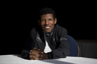 FILE - In this Wednesday, April 9, 2014 file photo, former marathon world record holder Ethiopia's Haile Gebrselassie, poses for photographers at a hotel in London. Gebrselassie says it was wrong to hold the track and field world championships in Qatar and marathon runners could have died from the heat. The women’s marathon Friday, Sept. 27, 2019 started at midnight to dodge the worst of the heat in Qatar but was still held in humidity that made it feel like 105 degrees (40 Celsius). Twenty-eight of the 68 women dropped out and one was briefly hospitalized. (AP Photo/Matt Dunham, File)