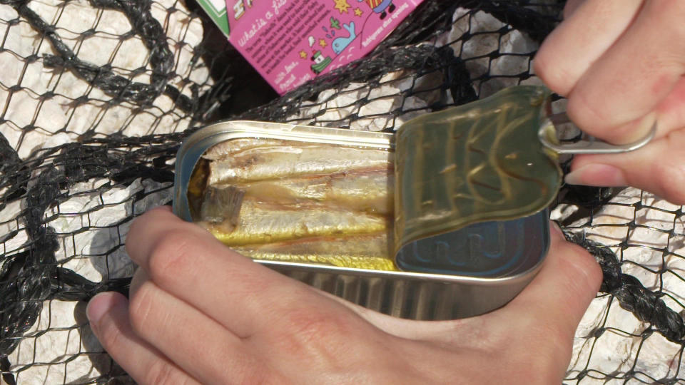 Opening a tin of Fishwife's sardines.  / Credit: CBS News