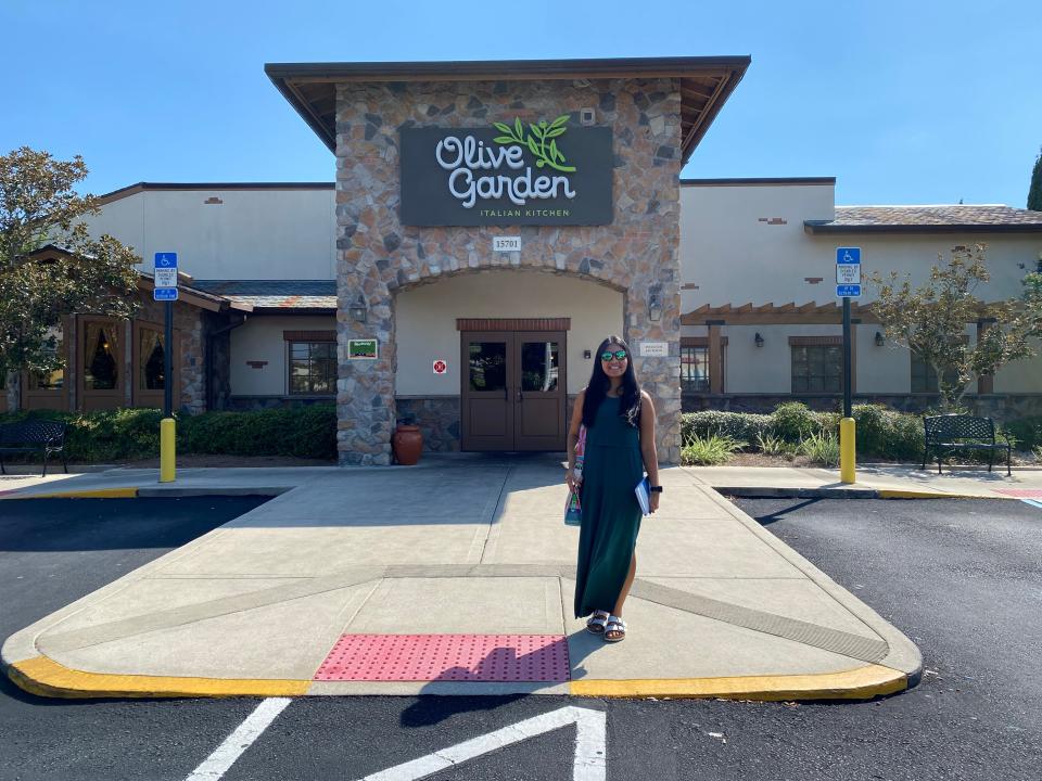 The writer stands in front of Olive Garden