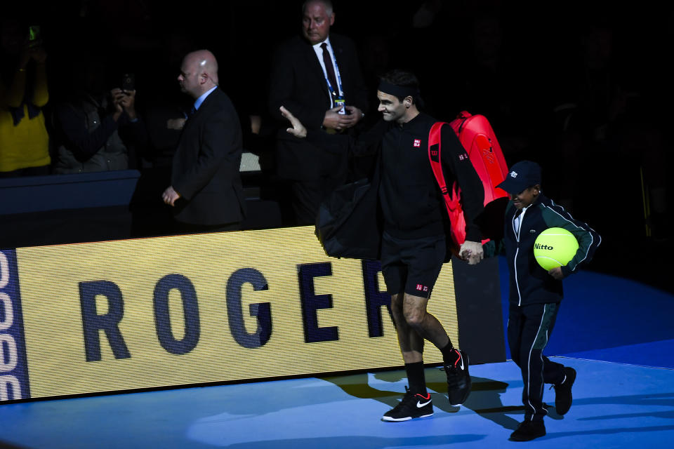 Roger Federer of Switzerland enters the court prior to his match against Novak Djokovic of Serbia during their ATP World Tour Finals singles tennis match at the O2 Arena in London, Thursday, Nov. 14, 2019. (AP Photo/Alberto Pezzali)