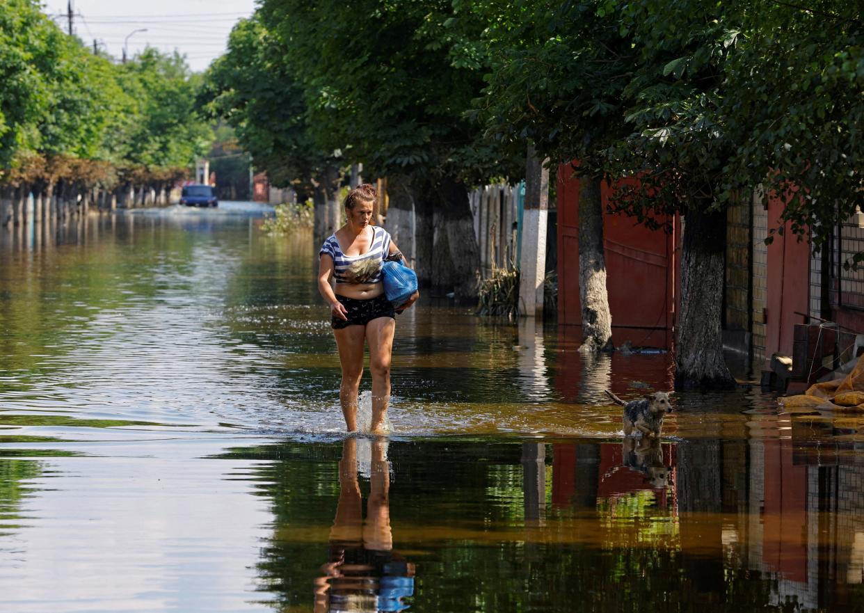 A woman walks along a street after floodwaters receded following the collapse of the Nova Kakhovka dam in the course of Russia-Ukraine conflict, in the town of Hola Prystan in the Kherson region (REUTERS)