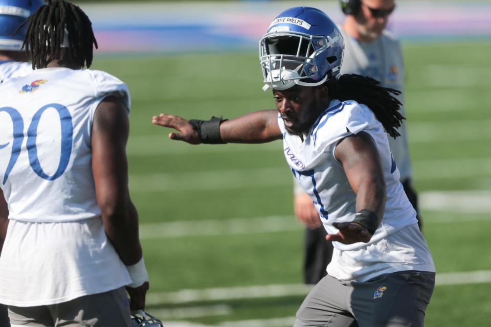 Kansas redshirt junior defensive end Lonnie Phelps Jr. (47) enjoys himself during a practice earlier this fall at David Booth Kansas Memorial Stadium.