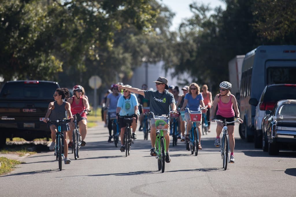 A man gives a tour guide on bikes.