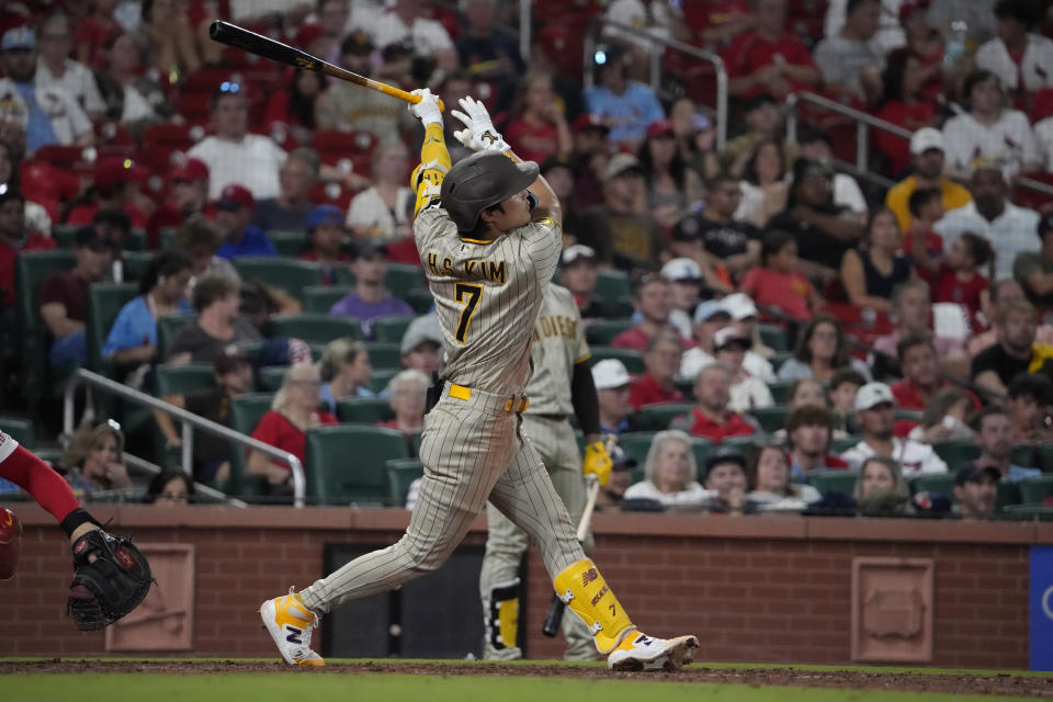 San Diego Padres' Ha-Seong Kim follows through on a sacrifice fly to score Matthew Batten during the eighth inning of a baseball game against the St. Louis Cardinals Tuesday, Aug. 29, 2023, in St. Louis. (AP Photo/Jeff Roberson)