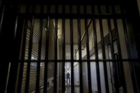 A guard stands behind bars at the Adjustment Center during a media tour of California's Death Row at San Quentin State Prison in San Quentin, California December 29, 2015. REUTERS/Stephen Lam