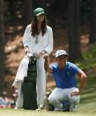 U.S. golfer Rickie Fowler has his girlfriend Alexis Randock caddie for him during the par 3 event at Augusta National Golf Course ahead of the 2015 Masters in Augusta, Georgia April 8, 2015. REUTERS/Phil Noble