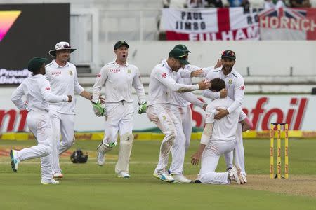 South Africa's Dale Steyn celebrates the wicket of England's James Taylor on his knees with his team mates during the first cricket test match in Durban, South Africa, December 26, 2015. REUTERS/Rogan Ward
