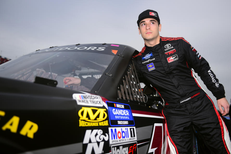 TALLADEGA, ALABAMA - OCTOBER 12: Anthony Alfredo, driver of the #15 Mavis Discount Tire Toyota, stands on the grid during qualifying for the NASCAR Gander Outdoor Truck Series Sugarlands Shine 250 at Talladega Superspeedway on October 12, 2019 in Talladega, Alabama. (Photo by Jared C. Tilton/Getty Images)