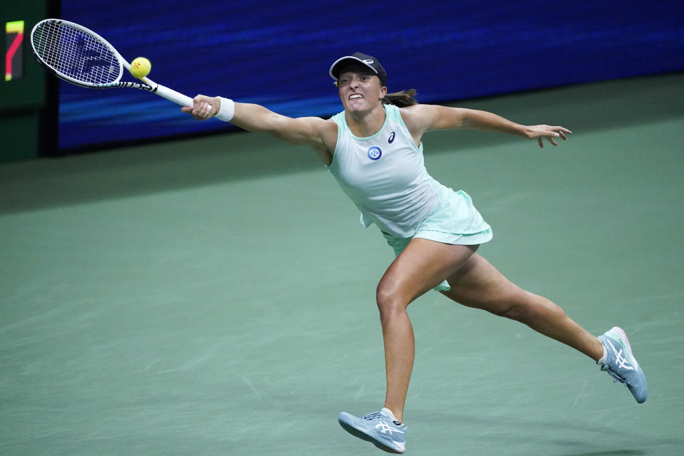 Iga Swiatek, of Poland, returns a shot to Aryna Sabalenka, of Belarus, during the semifinals of the U.S. Open tennis championships, Thursday, Sept. 8, 2022, in New York. (AP Photo/Julia Nikhinson)