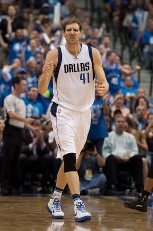 Dallas Mavericks forward Dirk Nowitzki (41) celebrates making a basket against the Oklahoma City Thunder during the second half in game three of the first round of the NBA Playoffs at American Airlines Center. The Thunder defeated the Mavericks 131-102. Mandatory Credit: Jerome Miron-USA TODAY Sports