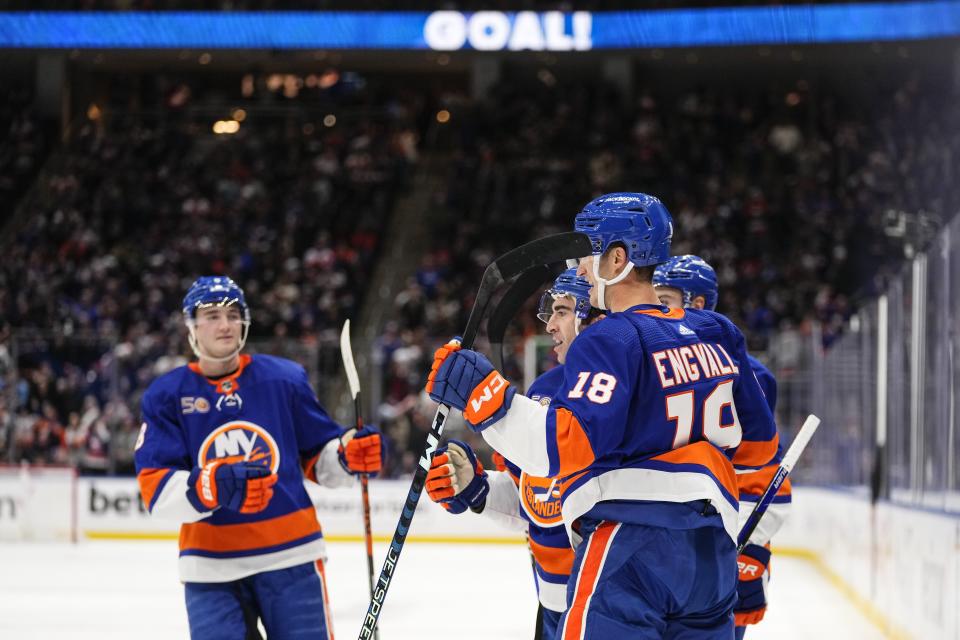 New York Islanders' Kyle Palmieri, center, celebrates with teammates after scoring a goal during the second period of an NHL hockey game against the New Jersey Devils Monday, March 27, 2023, in Elmont, N.Y. (AP Photo/Frank Franklin II)