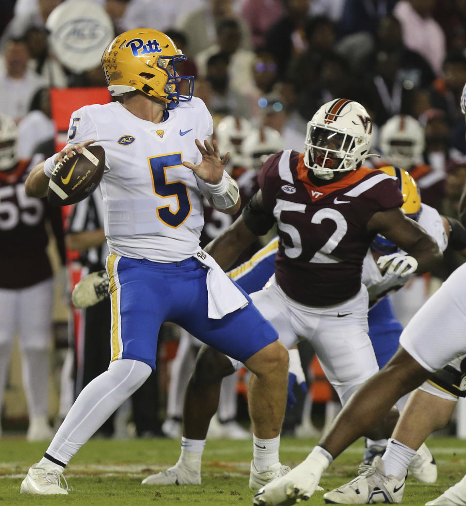 Pittsburgh quarterback Phil Jurkovec (5) looks to pass while rushed by Virginia Tech defender Antwaun Powell-Ryland (52) during the first quarter of an NCAA college football game Saturday, Sept. 30, 2023, in Blacksburg, Va. (Matt Gentry/The Roanoke Times via AP)