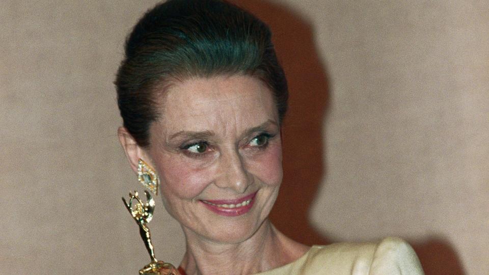 Actress Audrey Hepburn poses with the special Cecil B. DeMille Award at the Golden Globes. She was given the award for her contribution to the entertainment industry.