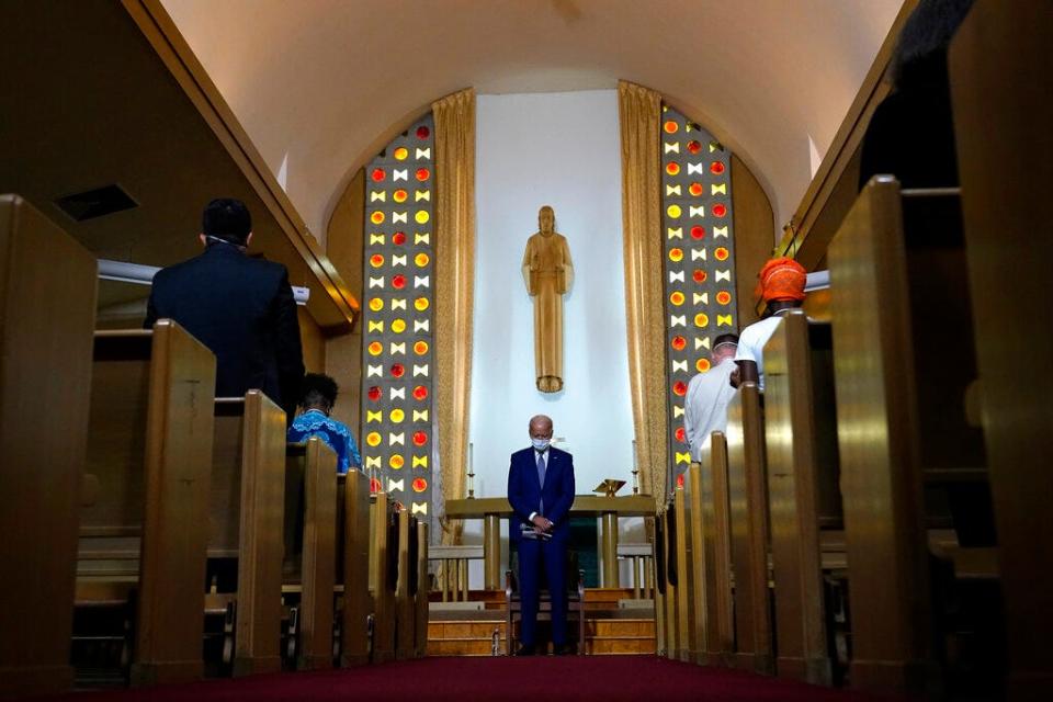 Then-candidate Joe Biden bows his head in prayer at Grace Lutheran Church in Kenosha, Wis.