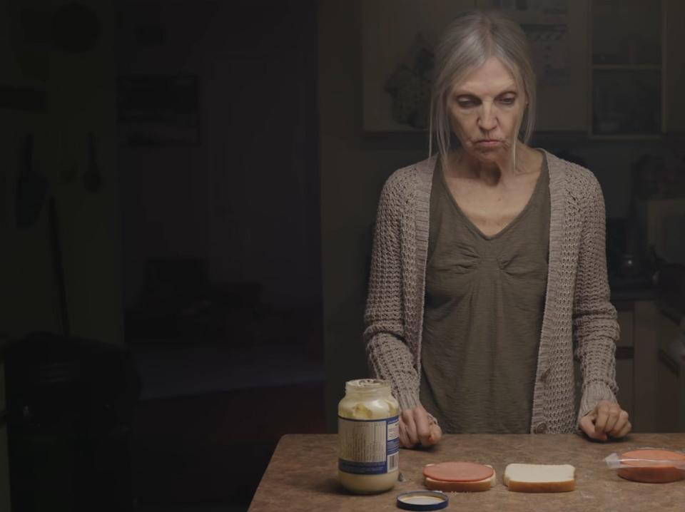 older woman making a sandwich