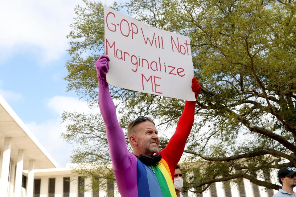 Tallahassee resident Glen Campbell, 53, holds up a sign at a rally at the Florida Capitol on Monday morning to protest House Bill 1557, also known as the "Don't Say Gay" bill by critics. 