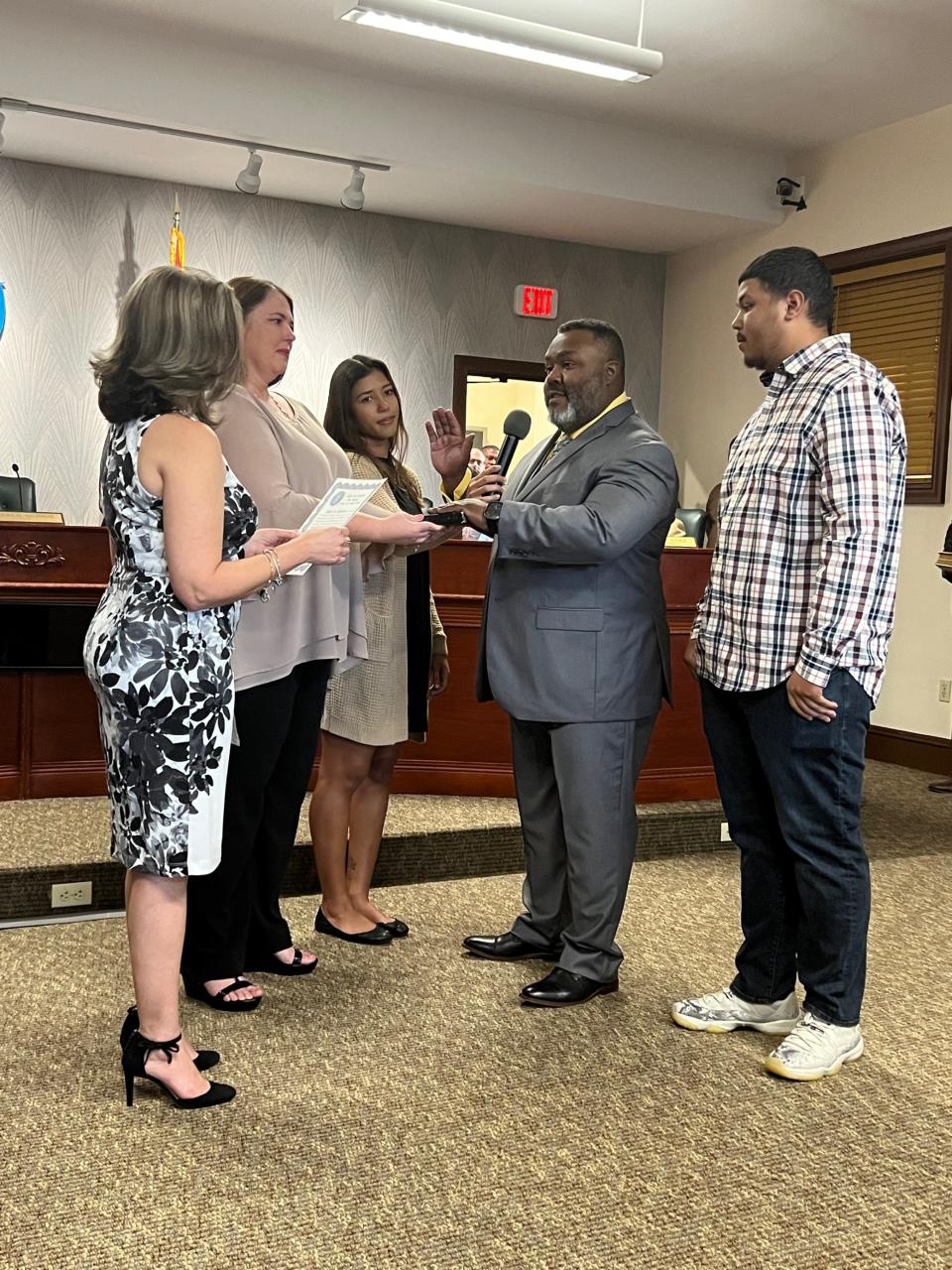 Roger Michaud, a longtime town commission member in Lake Park, takes the oath of office as mayor on Wednesday, March 22, 2023. Michaud is the town's first Black mayor. Surrounding him are his family: his wife Charity, his daughter Jordyn and his son Trenten.