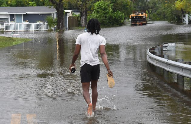 A man walks into a flooded street to check on his mother in the aftermath of Hurricane Ian on Sept. 29 in Orlando. (Photo: Anadolu Agency via Getty Images)