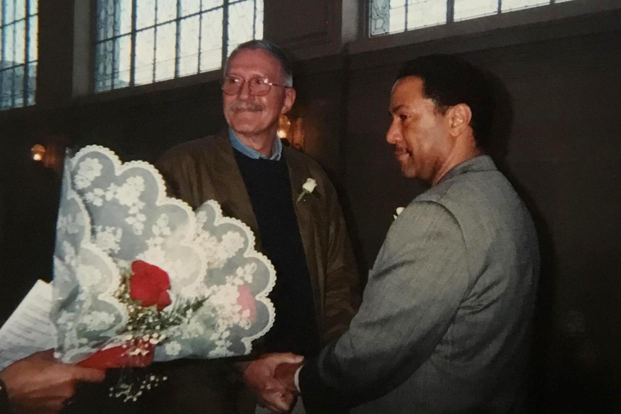 Raymond Cabone and Bradley Witherspoon hold hands during their wedding ceremony. (Family photo)