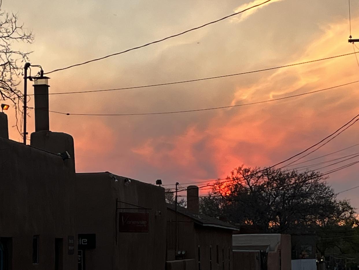 Smoke is seen at sunset in Sante Fe, New Mexico. 