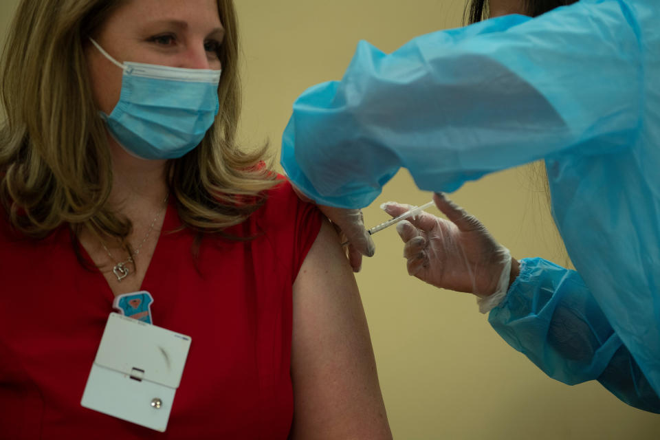 A person receives the Pfizer COVID-19 vaccine at the Goodwin House Bailey's Crossroads, a senior living community in Falls Church, Virginia, on Dec. 30, 2020. (Photo: BRENDAN SMIALOWSKI via Getty Images)