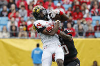 Maryland wide receiver Dontay Demus Jr., left, makes a catch against North Carolina State safety Sean Brown during the first half of the Duke's Mayo Bowl NCAA college football game in Charlotte, N.C., Friday, Dec. 30, 2022. (AP Photo/Nell Redmond)