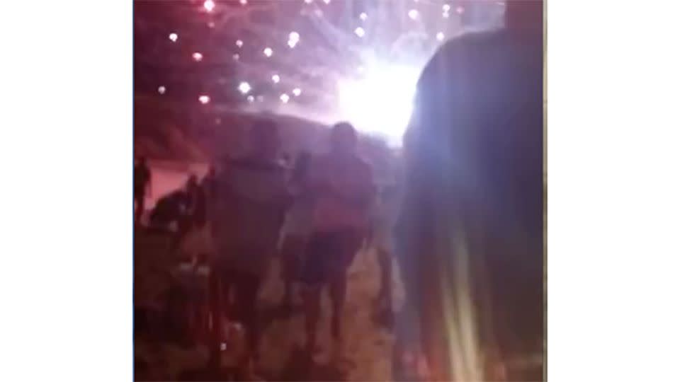 Something is not right here: NYE revellers in Brazil begin to run as they realise a fireworks display has gone wrong. Photo: Youtube/ regiane carlos