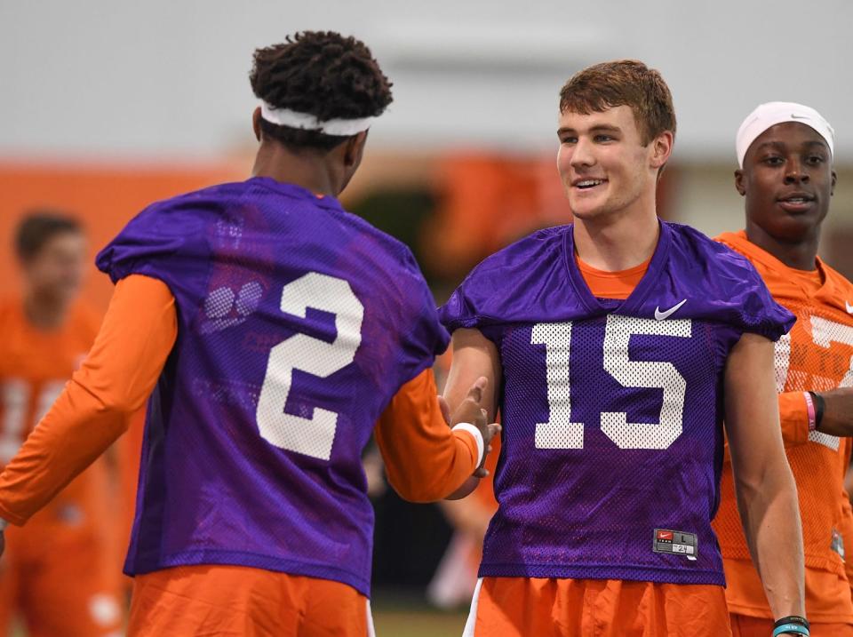 Former Clemson quarterback Hunter Johnson (15) talks to Kelly Bryant during a practice in 2017.