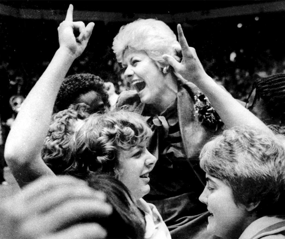 FILE - Louisiana Tech women's basketball coach Sonja Hogg is carried off the floor of McArthur Court in Eugene, Ore, following the Lady Techsters 79-59 win over Tennessee in the AIAW National Basketball Championship, March 29, 1981. (AP Photo/Harley Soltes, File)