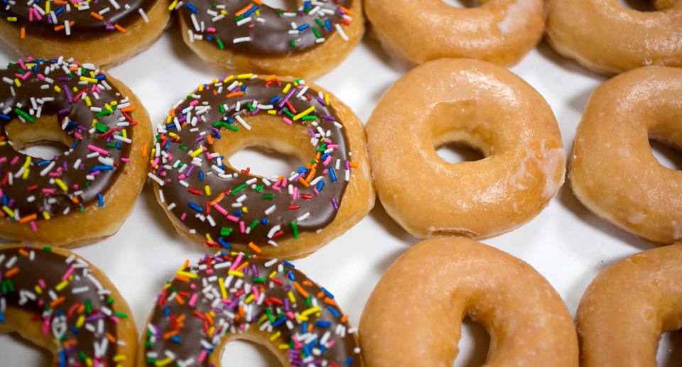 Photo shows box of Krispy Kreme donuts.