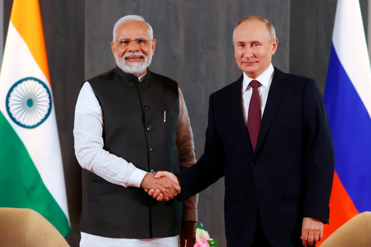 Russian President Vladimir Putin, right, and Indian Prime Minister Narendra Modi pose for a photo shaking hands prior to their talks on the sidelines of the Shanghai Cooperation Organisation (AP)