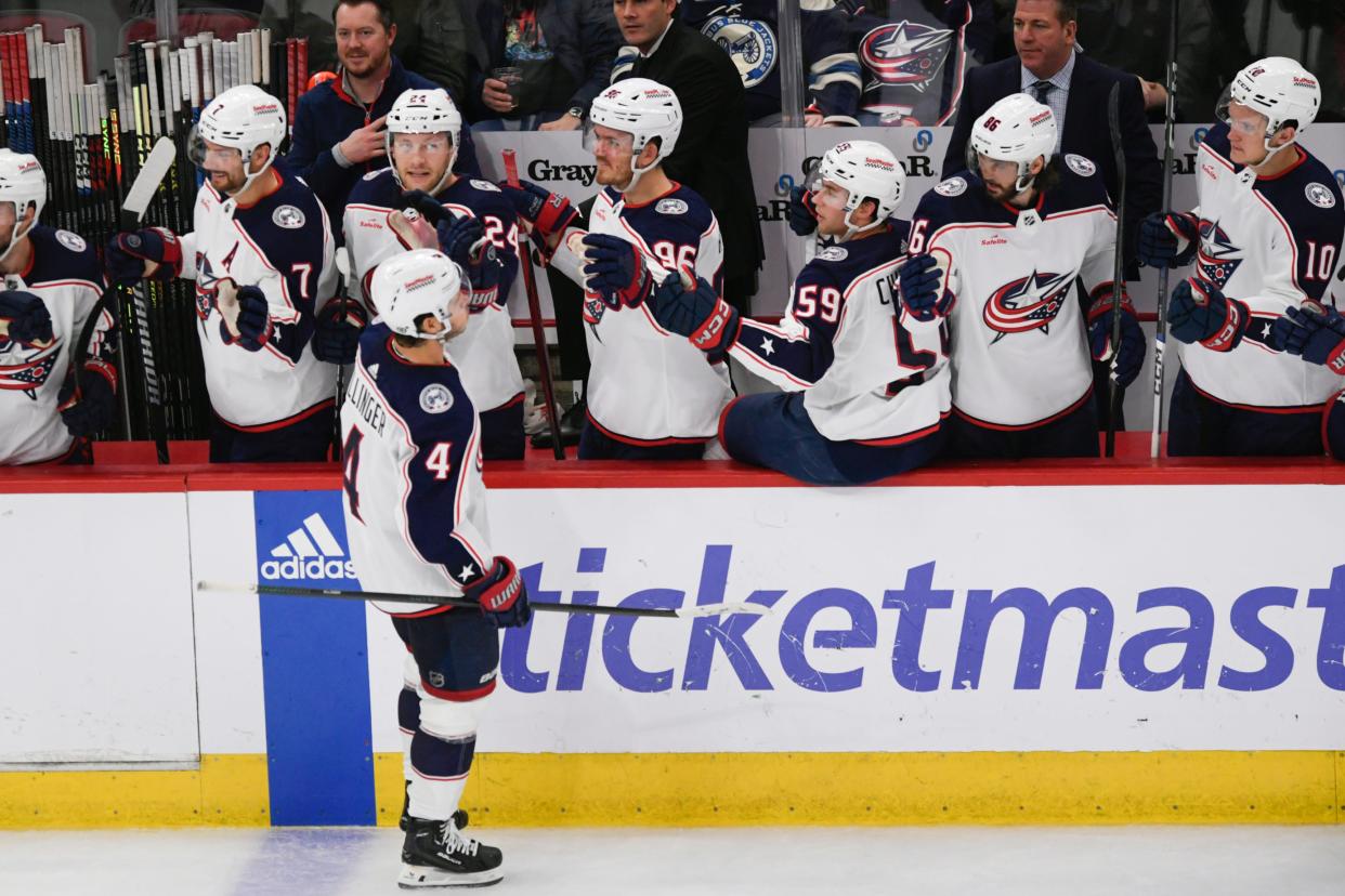 Columbus Blue Jackets' Cole Sillinger (4) celebrates with teammates at the bench after scoring a goal during the second period of an NHL hockey game against the Chicago Blackhawks, Saturday, March 2, 2024, in Chicago. (AP Photo/Paul Beaty)