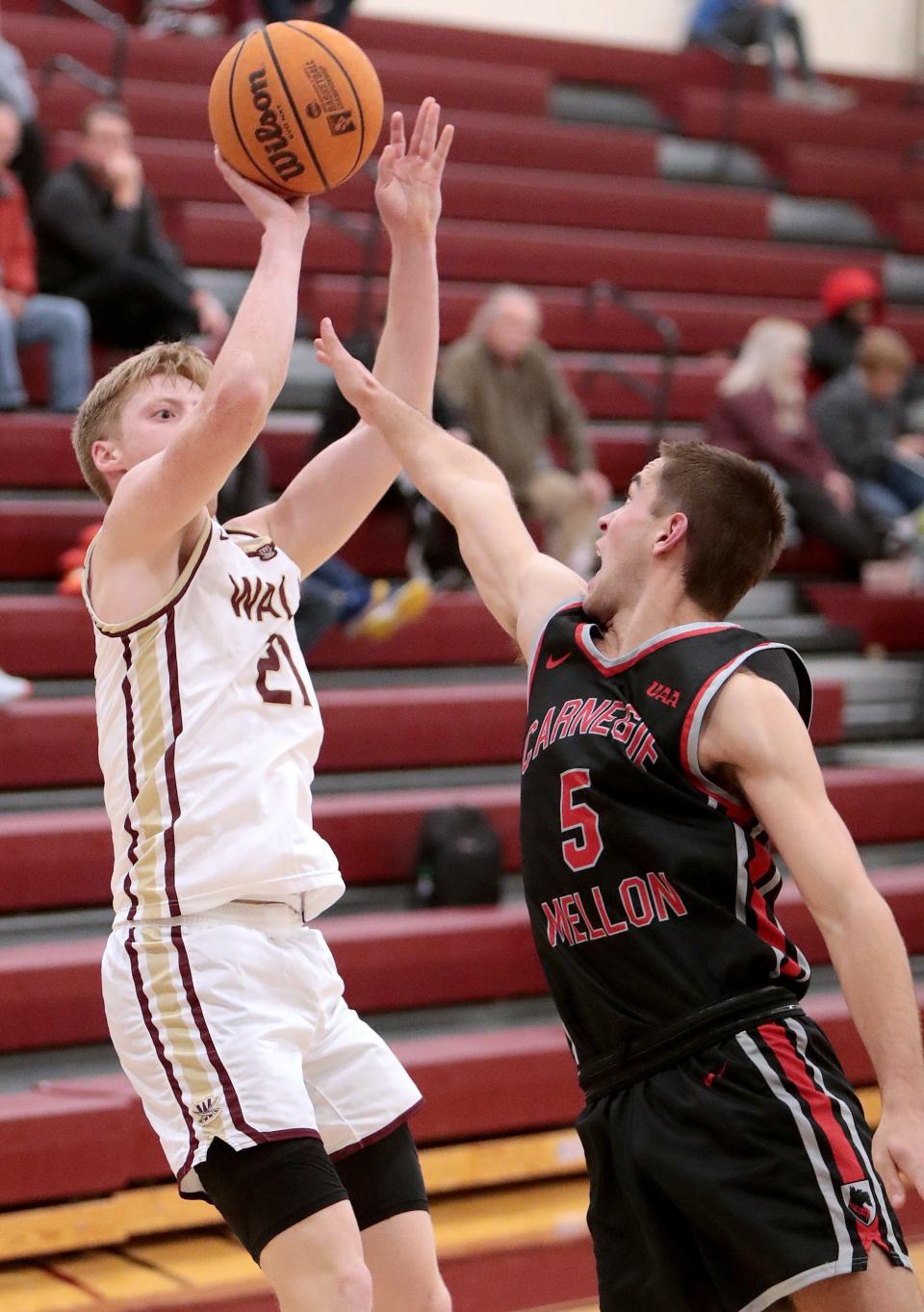 Walsh's Garrison Keeslar (left) shoots with defense from Carnegie Mellon's Buckley DeJardin  during a game last week. It was Keeslar's final game before suffering an ankle injury that is expected to keep out three to five weeks.