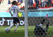 France's Antoine Griezmann, left, celebrates after scoring his sides first goal past Hungary's goalkeeper Peter Gulacsi during the Euro 2020 soccer championship group F match between Hungary and France at the Ferenc Puskas stadium in Budapest, Hungary Saturday, June 19, 2021. (Tibor Illyes/Pool via AP)