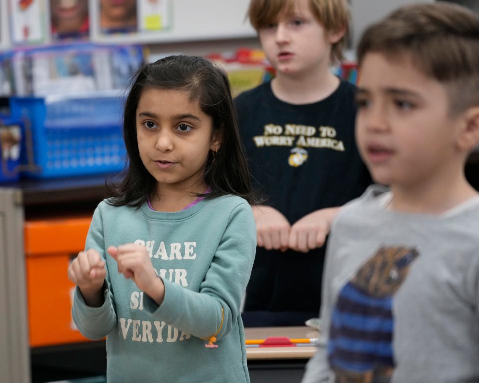 First-grader Rokaya Flayyih, left, takes part in an exercise as part of a reading lesson at General Mitchell Elementary School in Cudahy.