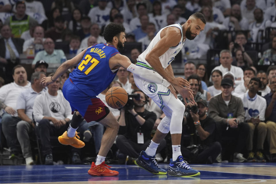 Minnesota Timberwolves center Rudy Gobert loses control of the basketball as Denver Nuggets guard Jamal Murray (27) defends during the first half of Game 6 of an NBA basketball second-round playoff series Thursday, May 16, 2024, in Minneapolis. (AP Photo/Abbie Parr)