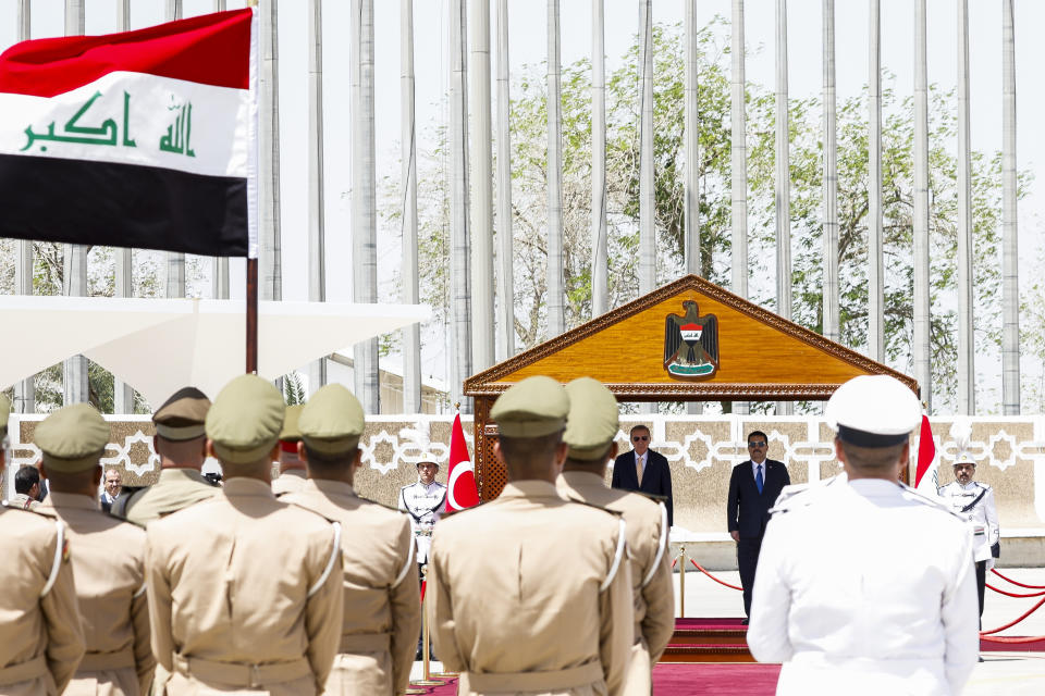 Iraqi Prime Minister Mohammed Shia al-Sudani, right, and Turkish President Recep Tayyip Erdogan attend a welcoming ceremony at Baghdad International Airport, in Baghdad, Iraq, Monday April 22, 2024. (Thaier Al-Sudani/Pool via AP)