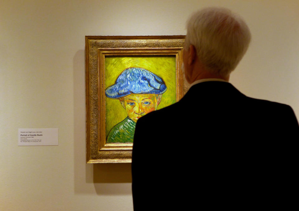 A visitor studies Vincent van Gogh's "Portrait of Camille Roulin," on display at The Phillips Collection in Washington. In the midst of the shutdown of federally funded museums, the private Phillips Collection is launching the first major exhibition of Vincent van Gogh’s artwork in Washington in 15 years. (AP Photo/Molly Riley)