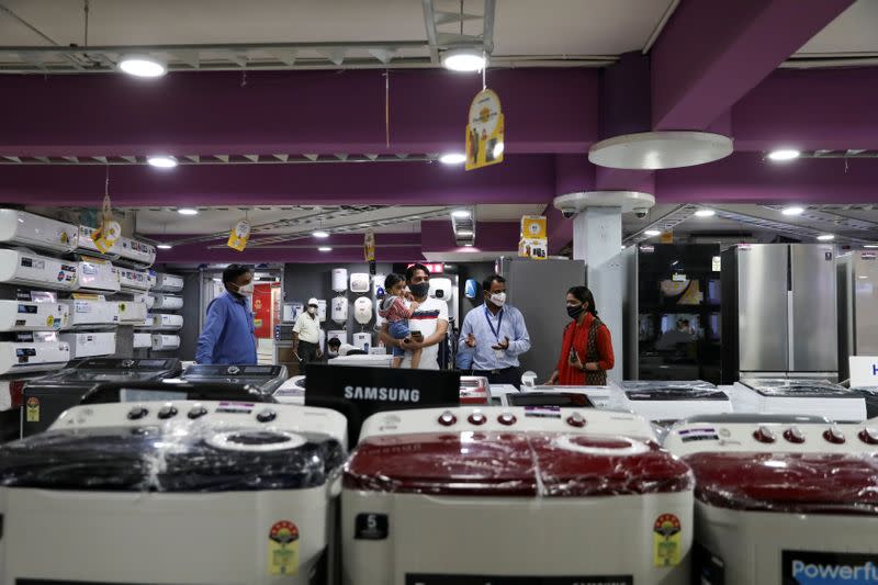 A customer with his family is seen at an electronics and appliances shop in Jaipur