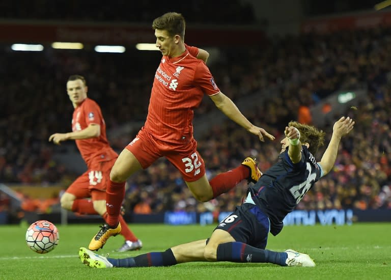 Liverpool's midfielder Cameron Brannagan (C) is challenged by West Ham United's striker Nikica Jelavic (R) during the English FA Cup fourth round football match at Anfield in Liverpool, on January 30, 2016