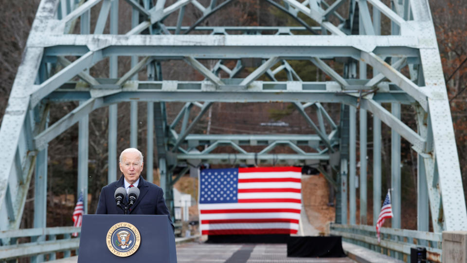 President Biden stands at a podium set up on a bridge in Woodstock, New Hampshire. 