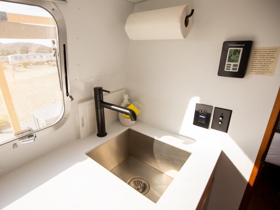 Autocamp Joshua Tree's Airsteram trailer with a sink, paper towels by a window.