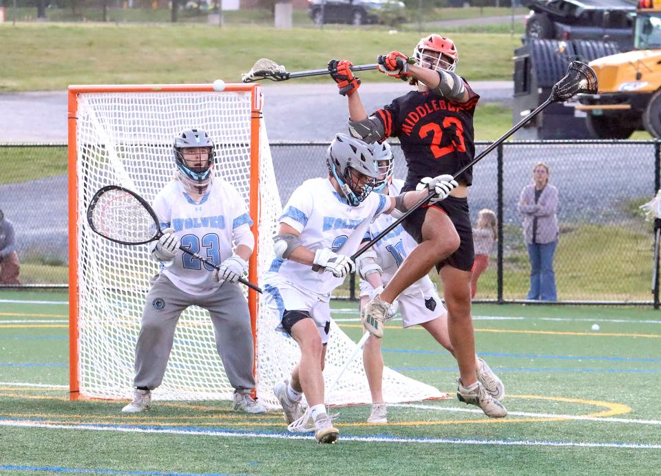 Middlebury's Owen Lawton takes a behind the back shot on goal during the Tiger's 14-6 loss to South Burlington in the Division I championship game at UVM's Virtue Field.