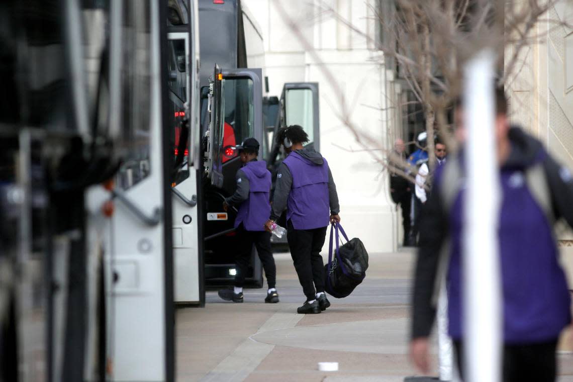 TCU players and staff board a bus to the College Football Championships, outside of the Amon G. Carter Stadium in Fort Worth on Friday, Jan. 6, 2023. As the team left, fans lined nearby streets to cheer them on.