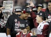 Florida Seminoles head coach Jimbo Fisher (R) celebrates with quarterback Jameis Winston after they defeated the Auburn Tigers to win the BCS Championship football game in Pasadena, California January 6, 2014. REUTERS/Lucy Nicholson