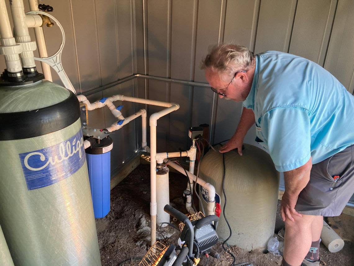 Robbie O’Neal checks a water filtration system installed by regulators after high levels of PFAS were found on his family’s farm.